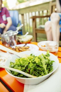 Close up of bowl of salad on lunch table