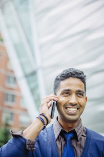 Indian businessman talking on cell phone outdoors