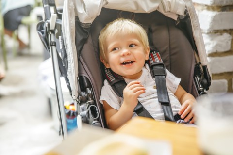 Mixed race boy sitting in stroller chair