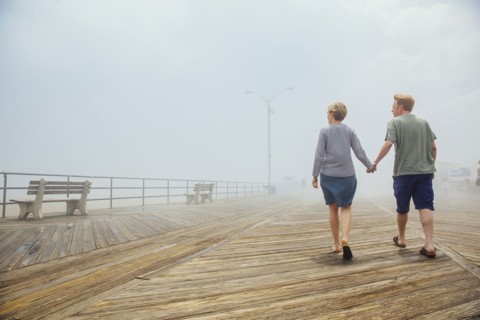 Couple holding hands on wooden boardwalk