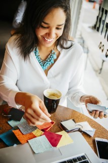 Businesswoman examining fabric samples in cafe