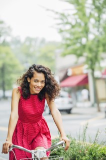 Mixed race woman riding bicycle in city