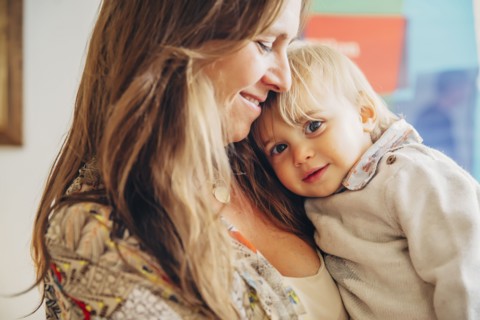 Caucasian mother holding baby son
