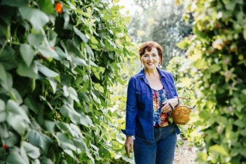 Caucasian woman picking vegetables in garden