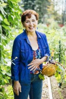 Caucasian woman picking vegetables in garden