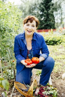 Caucasian woman holding tomatoes in garden