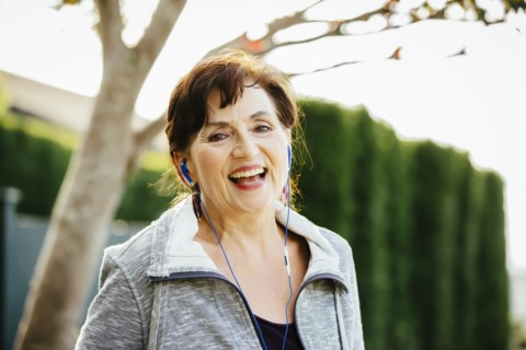 Caucasian woman listening to earbuds outdoors