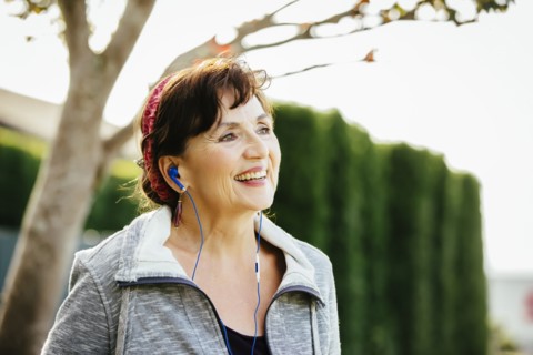 Caucasian woman listening to earbuds outdoors