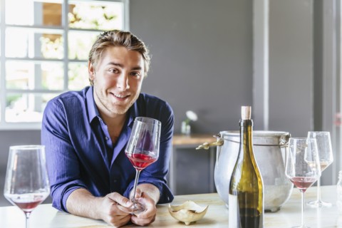 Caucasian man drinking wine in restaurant