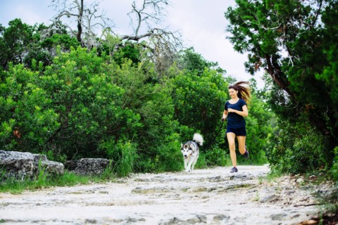 Caucasian woman jogging with dog