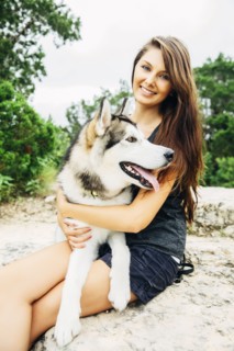 Caucasian woman petting dog outdoors