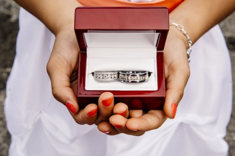 Mixed race girl holding wedding rings
