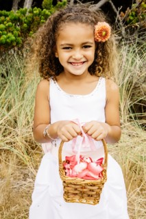Mixed race girl carrying flower basket