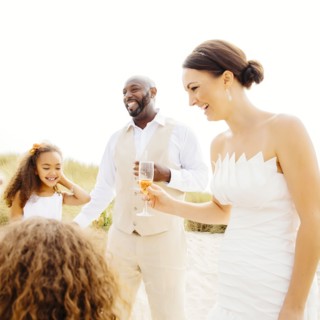 Bride and groom celebrating with flower girl daughters