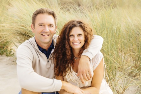 Caucasian couple smiling on beach