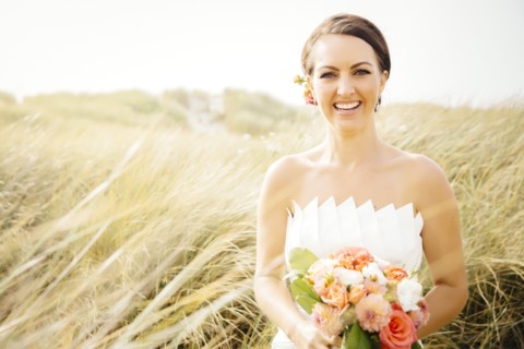 Caucasian bride standing in grass