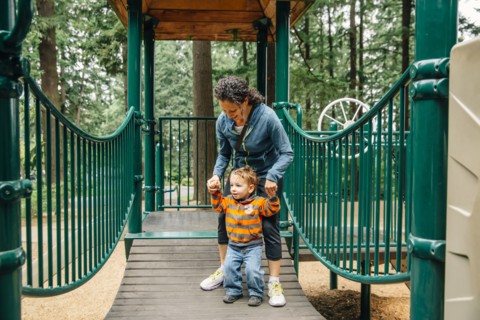 Caucasian mother and son playing on playground