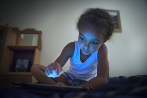 Mixed race girl using digital tablet