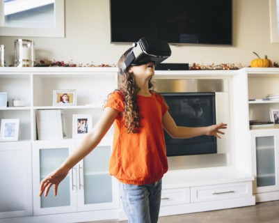 Mixed race girl using virtual reality goggles