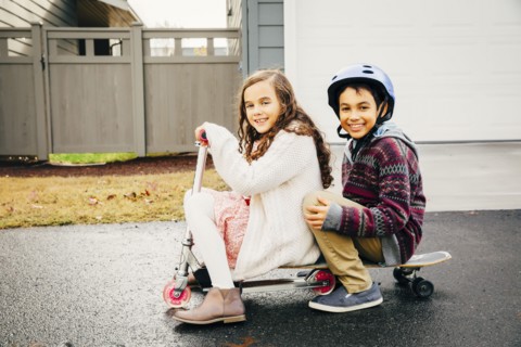 Mixed race children playing outdoors