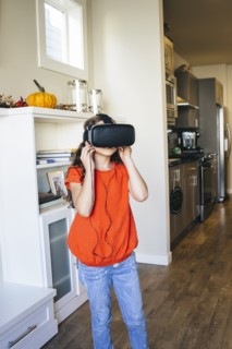Mixed race girl using virtual reality goggles