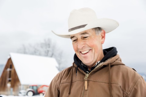 Caucasian farmer smiling in snow