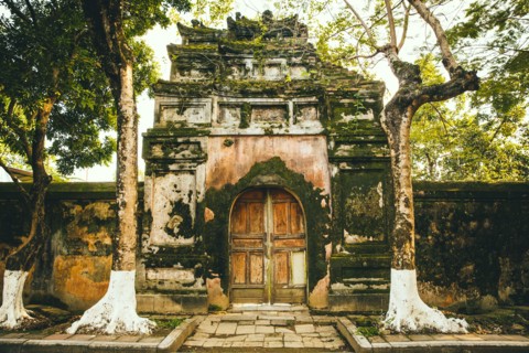 Mossy ornate archway and fence
