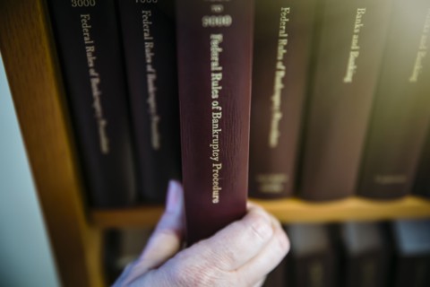Caucasian woman selecting reference book from shelf