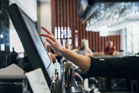 Caucasian  bartender using computer