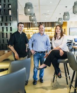Caucasian men and woman smiling in restaurant