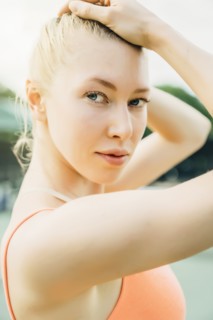 Caucasian woman posing with hands in hair