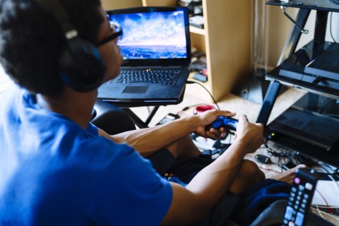 Black man playing video game