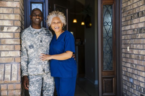 Black couple smiling in doorway