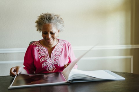 Black woman enjoying photo album
