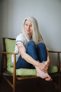 Caucasian woman sitting in armchair looking away