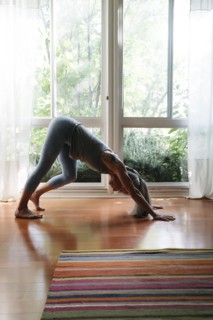 Caucasian woman bending on floor stretching