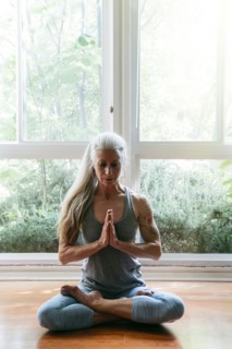 Caucasian woman meditating on floor
