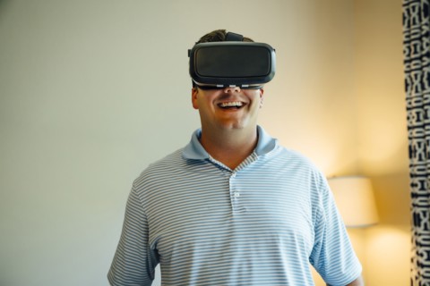 Caucasian man wearing virtual reality goggles
