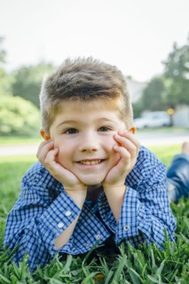 Smiling Caucasian boy posing in grass