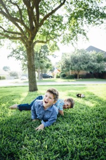 Smiling Caucasian boys playing in grass