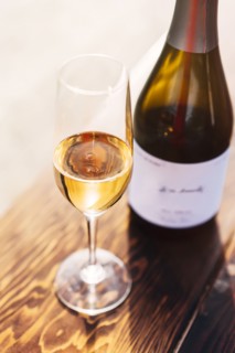 White wine in glass with bottle