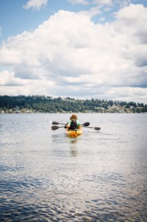 Man and woman in kayak holding paddles