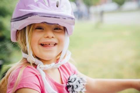 Smiling Mixed Race girl wearing helmet