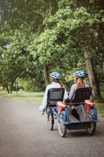 Caucasian mother and daughter riding tandem bicycle