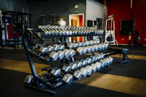 Dumbbells on rack in gymnasium
