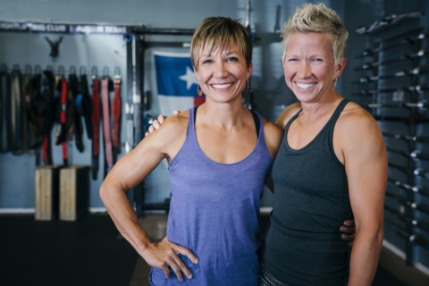 Smiling Caucasian women posing in gymnasium
