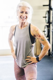 Caucasian woman smiling in gymnasium