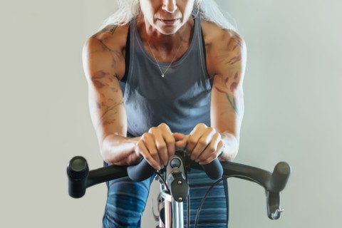 Caucasian woman riding stationary bicycle