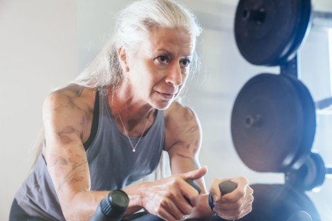 Caucasian woman riding stationary bicycle