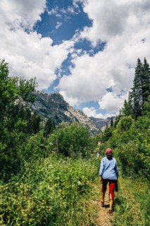 Caucasian woman hiking on path in mountains
